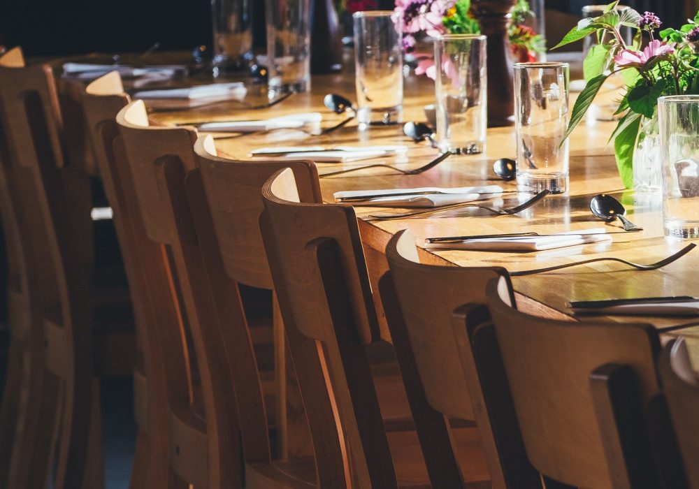 Long tables set with flowers and candles running away from the camera